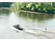 Exciting water activity with a boat pulling a water skier on a sunny day at 5888 Wood Duck Way, Catawba, NC 28609