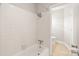 Neutral bathroom featuring white tile, tub, shower, and beige flooring at 5949 Quail Hollow Rd # E, Charlotte, NC 28210