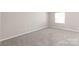 Bright bedroom with neutral carpet, providing a serene space ready for personalization at 5949 Quail Hollow Rd # E, Charlotte, NC 28210