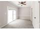 Bright bedroom featuring a ceiling fan and sliding glass doors to the outside at 5949 Quail Hollow Rd # E, Charlotte, NC 28210