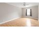 Light and airy bedroom with laminate floors, a ceiling fan and large window at 5949 Quail Hollow Rd # E, Charlotte, NC 28210
