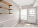 Eat-in kitchen area featuring open shelving and rear access at 5949 Quail Hollow Rd # E, Charlotte, NC 28210