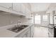 Eat-in kitchen boasts stainless steel sink, appliances, and rear entrance at 5949 Quail Hollow Rd # E, Charlotte, NC 28210