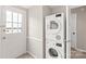 Laundry area with stacked washer and dryer near exterior door at 5949 Quail Hollow Rd # E, Charlotte, NC 28210