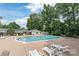 Community pool with surrounding lounge area and mature trees at 5949 Quail Hollow Rd # E, Charlotte, NC 28210