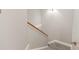 Carpeted stairwell with neutral paint and wooden handrail at 5949 Quail Hollow Rd # E, Charlotte, NC 28210