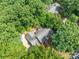 Aerial view of a home surrounded by lush trees, showcasing its secluded backyard and roof at 654 9Th N St, Albemarle, NC 28001