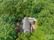 Overhead shot of a home nestled among green trees, featuring a boat and driveway at 654 9Th N St, Albemarle, NC 28001