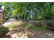 Lush backyard oasis with mature trees and space for outdoor recreation at 654 9Th N St, Albemarle, NC 28001