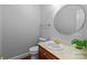 Cozy half bathroom with a round mirror, pedestal sink, and natural light at 654 9Th N St, Albemarle, NC 28001