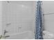 Basic bathroom with standard tub, white tile, and a blue polka dot shower curtain at 654 9Th N St, Albemarle, NC 28001
