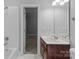 Neutral bathroom with a white shower tub combo, framed mirror, and a stained wood vanity at 654 9Th N St, Albemarle, NC 28001