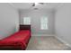 This bedroom offers neutral walls, carpeted floors and natural light from the two windows at 654 9Th N St, Albemarle, NC 28001