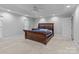Spacious bedroom with a tray ceiling, natural light, and ensuite bath access at 654 9Th N St, Albemarle, NC 28001