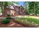 Stately brick home featuring meticulous landscaping and a well-manicured front lawn at 654 9Th N St, Albemarle, NC 28001