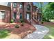 Charming two-story brick home with mature trees and a paver walkway at 654 9Th N St, Albemarle, NC 28001
