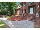 Charming brick home with a welcoming front entrance and well-maintained landscaping with beautiful brick walkway at 654 9Th N St, Albemarle, NC 28001
