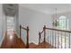 Elegant foyer with wood floors, staircase, chandelier, and natural light from a large arched window at 654 9Th N St, Albemarle, NC 28001