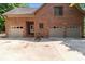 Spacious three-car garage with brick exterior and ample parking space at 654 9Th N St, Albemarle, NC 28001