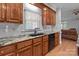 Well-appointed kitchen with granite countertops, dark cabinetry, and modern appliances at 654 9Th N St, Albemarle, NC 28001