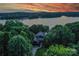 Gorgeous waterfront home enveloped by trees and a stunning sunset view at 7221 High Point Ct, Charlotte, NC 28278