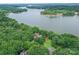 Stunning aerial view of waterfront home surrounded by trees and the serene lake at 7221 High Point Ct, Charlotte, NC 28278