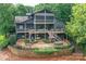 Multi-level decks and patio create an inviting outdoor space, surrounded by lush greenery and a brick retaining wall at 7221 High Point Ct, Charlotte, NC 28278