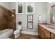 Bathroom featuring a tub-shower combo, decorative art, and single sink vanity, with a window offering natural light at 7221 High Point Ct, Charlotte, NC 28278