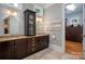Bathroom featuring double sinks, a storage cabinet, and granite countertops at 7221 High Point Ct, Charlotte, NC 28278
