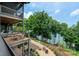 Spacious deck features outdoor seating, fire pit, and stunning lake views, perfect for relaxation and entertaining at 7221 High Point Ct, Charlotte, NC 28278