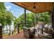 Inviting outdoor deck with wood ceiling, comfortable seating, and scenic lake views for relaxing or entertaining at 7221 High Point Ct, Charlotte, NC 28278