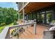 Multi-level deck with an outdoor seating area and verdant foliage at 7221 High Point Ct, Charlotte, NC 28278
