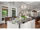 Bright dining room with modern light fixture, bench, and a view of the outdoors at 7221 High Point Ct, Charlotte, NC 28278