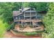 Expansive home featuring a multi-tiered deck and landscaped patio with fire pit and outdoor seating at 7221 High Point Ct, Charlotte, NC 28278
