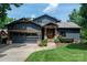 Charming home with a gray exterior, complemented by wood accents, stone details, and a well-manicured lawn at 7221 High Point Ct, Charlotte, NC 28278