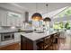 Bright kitchen with a large island, modern pendant lights, and open dining area, perfect for entertaining at 7221 High Point Ct, Charlotte, NC 28278