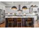 Kitchen showcasing a spacious island with bar stool seating, white cabinetry, and modern pendant lighting at 7221 High Point Ct, Charlotte, NC 28278