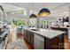 Bright kitchen featuring a large island with marble countertop and stainless steel dishwasher at 7221 High Point Ct, Charlotte, NC 28278