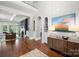 Open living area featuring hardwood floors, arched entryways, and built-in shelving at 7221 High Point Ct, Charlotte, NC 28278