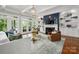 Cozy living room with a fireplace, built-in shelving, and French doors for seamless indoor-outdoor living at 7221 High Point Ct, Charlotte, NC 28278
