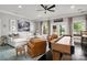 Spacious living room with a comfortable white sofa, leather chairs, and shuffleboard table, creating an inviting atmosphere at 7221 High Point Ct, Charlotte, NC 28278