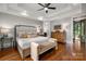Main bedroom featuring a tray ceiling, hardwood floors, and neutral decor at 7221 High Point Ct, Charlotte, NC 28278