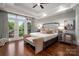 Main bedroom with a tray ceiling, a sitting area, and French doors to a balcony at 7221 High Point Ct, Charlotte, NC 28278