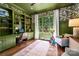 Office space with built-in shelves, desk, hardwood floors, and a large window at 7221 High Point Ct, Charlotte, NC 28278
