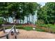 Brick patio and lakeside lawn with verdant foliage and tranquil lake views at 7221 High Point Ct, Charlotte, NC 28278