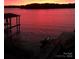 Gorgeous pink sunset over the lake, featuring dock and boat slip at 7221 High Point Ct, Charlotte, NC 28278