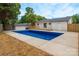 Beautiful in-ground pool and well maintained backyard with a deck, perfect for entertaining at 756 Logan St, Mooresville, NC 28115