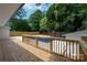 Backyard features a wooden deck and a beautiful in-ground pool with lush landscaping at 756 Logan St, Mooresville, NC 28115