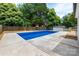 Serene backyard with a private in-ground swimming pool surrounded by lush greenery at 756 Logan St, Mooresville, NC 28115