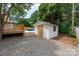Backyard view featuring a pool, storage shed, wooden deck, and a gravel area at 756 Logan St, Mooresville, NC 28115